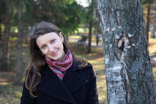 beautiful girl in a park on an autumn-day