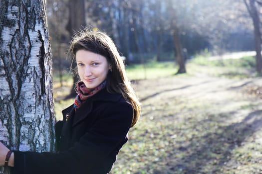 beautiful girl in a park on an autumn-day