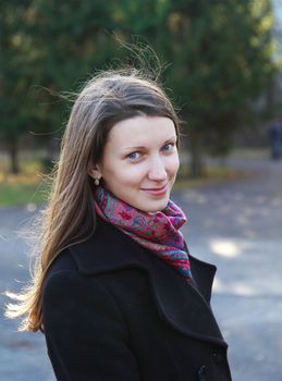 beautiful girl in a park on an autumn-day