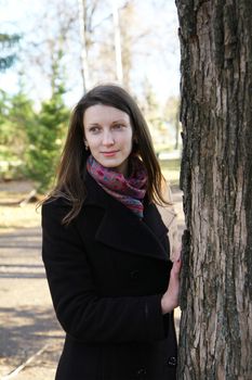 beautiful girl in a park on an autumn-day