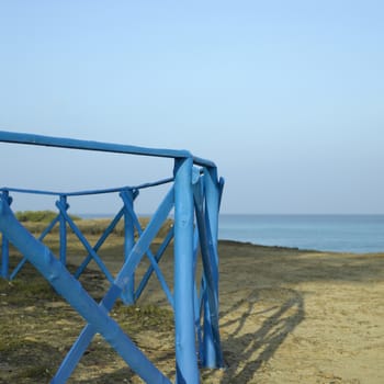 Blue wooden fence near the sea
