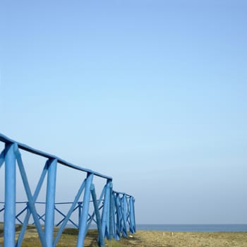 Blue wooden fence near the sea