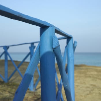 Blue wooden fence near the sea