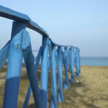 Blue wooden fence near the sea