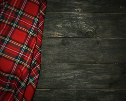 tartan textile on wooden background