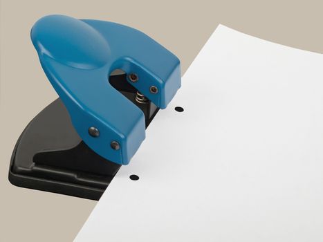 drilling hole punch with paper, studio shot