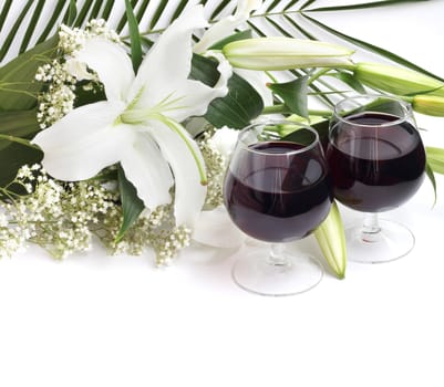 Wine and flowers on white background