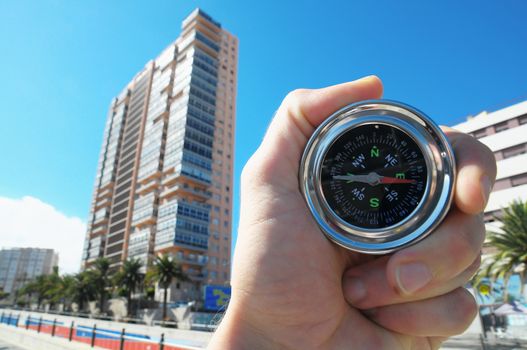 Orientation Concept a Male Hand Holding a Metal Compass in a City