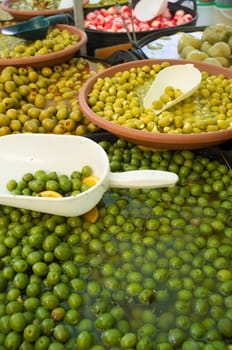 Assorted pickled and stuffed olives on a market stall