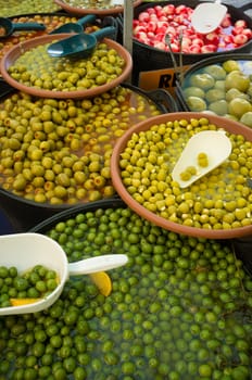 Assorted pickled and stuffed olives on a market stall