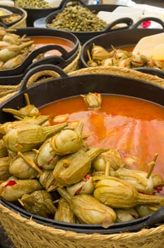 Market stall displaying an assortment of pickled aubergines