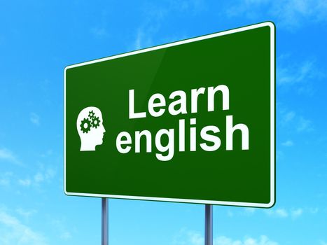 Education concept: Learn English and Head With Gears icon on green road (highway) sign, clear blue sky background, 3d render