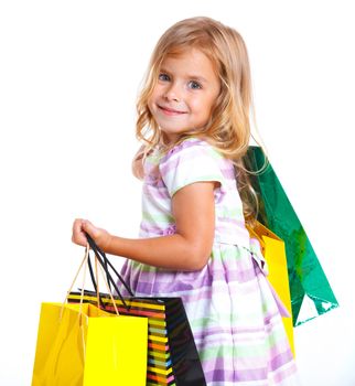 Shopping little girl happy smiling holding shopping bags isolated on white background.