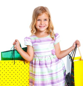 Shopping little girl happy smiling holding shopping bags isolated on white background.