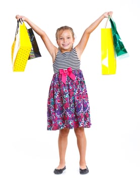 Shopping little girl happy smiling holding shopping bags isolated on white background.