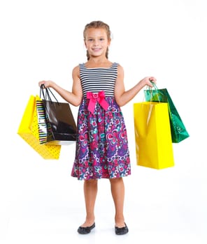 Shopping little girl happy smiling holding shopping bags isolated on white background.