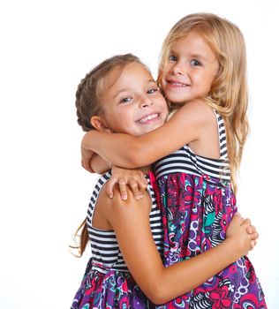 Portrait of two beautiful little girls happy smiling on studio. Isolated white background