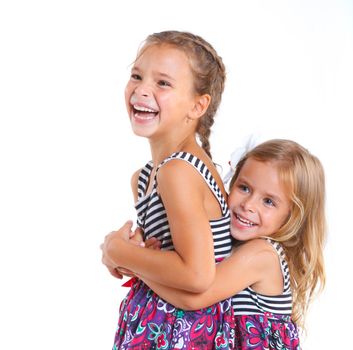 Portrait of two beautiful little girls happy smiling on studio. Isolated white background
