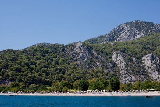 Beach under a wooded mountain in Asia Minor
