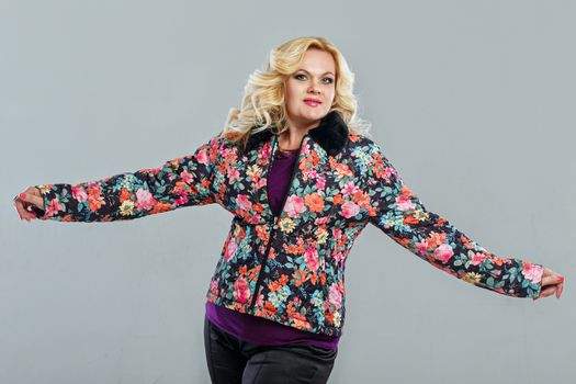 Adult woman in a warm jacket, photographed in the studio