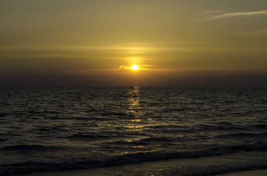 Yellow Sun Set in The Middle of The Ocean and very very small boat