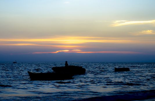 beautiful natural background the sun sets with clouds and black Silhouette boat on sea