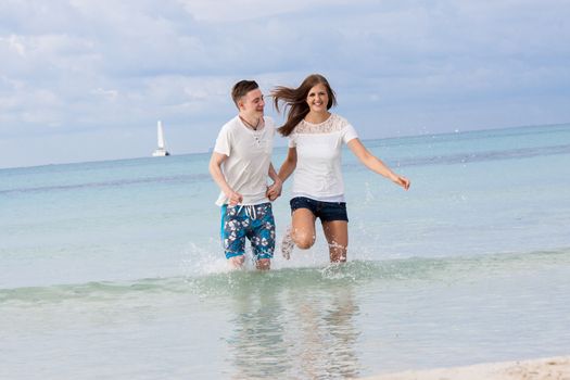 young happy couple in summer holiday vacation summertime beach