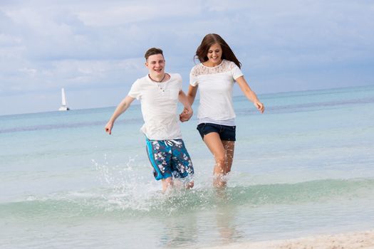 young happy couple in summer holiday vacation summertime beach