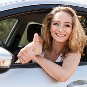 young attractive happy woman sitting in car summer portrait outdoor