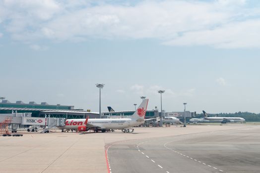 SINGAPORE - SEP 11: Loin Air and Singapore airlines planes stand in Changi airport on SEP 11, 2012  in Singapore. Changi International Airport is the main airport in Singapore.