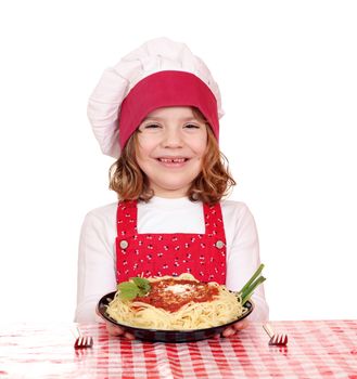 happy little girl cook with spaghetti on table