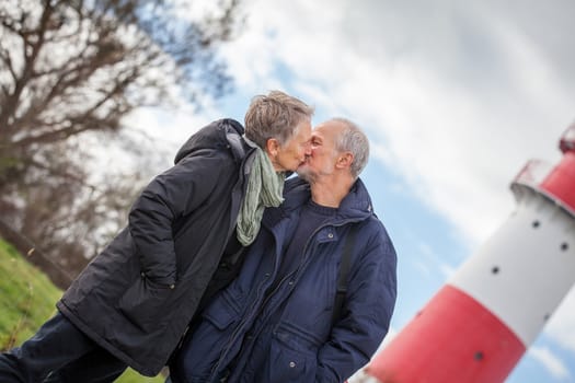 happy mature couple relaxing baltic sea dunes in autumn