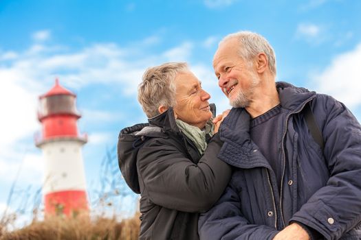 happy mature couple relaxing baltic sea dunes in autumn