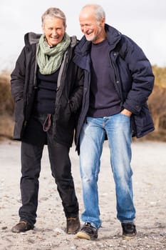 happy mature couple relaxing baltic sea dunes in autumn