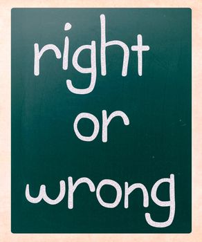 "Right or wrong" handwritten with white chalk on a blackboard