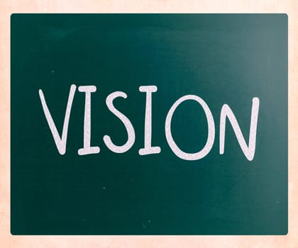 "Vision" handwritten with white chalk on a blackboard