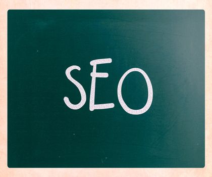 The word "SEO" handwritten with white chalk on a blackboard