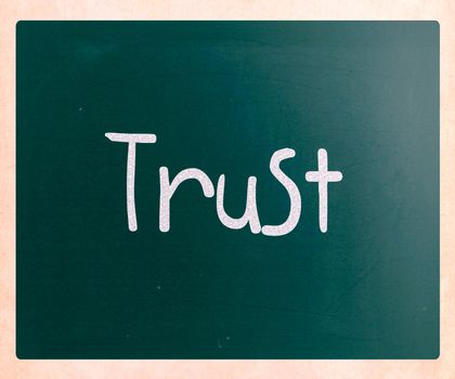 The word "Trust" handwritten with white chalk on a blackboard