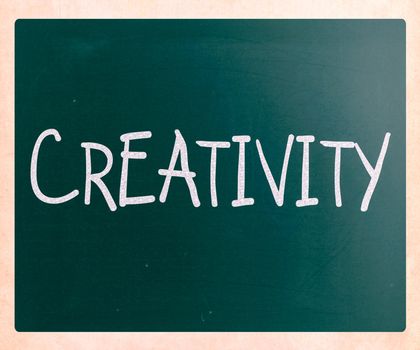 The word "Creativity" handwritten with white chalk on a blackboard
