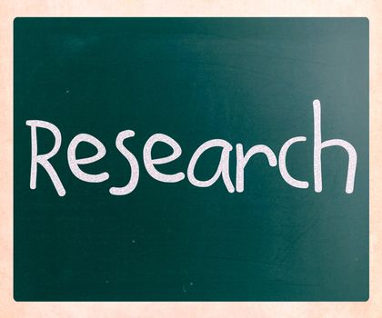 "Research" handwritten with white chalk on a blackboard