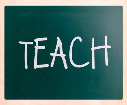 "Teach" handwritten with white chalk on a blackboard
