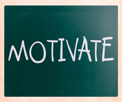 "Motivate" handwritten with white chalk on a blackboard