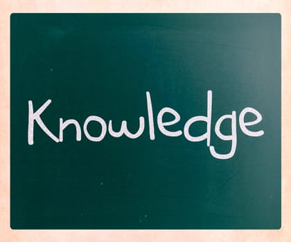 "Knowledge" handwritten with white chalk on a blackboard