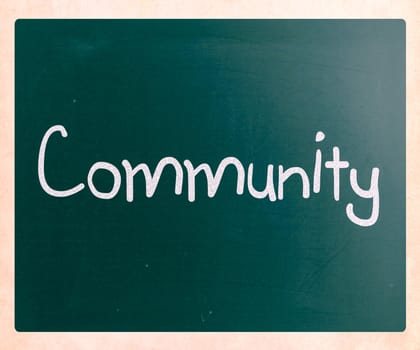 "Community" handwritten with white chalk on a blackboard