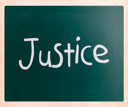"Justice" handwritten with white chalk on a blackboard