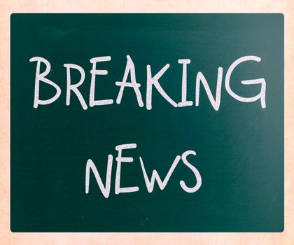 "Breaking news" handwritten with white chalk on a blackboard
