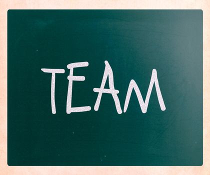 The word "TEAM" handwritten with white chalk on a blackboard