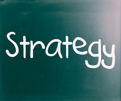 "Strategy" handwritten with white chalk on a blackboard
