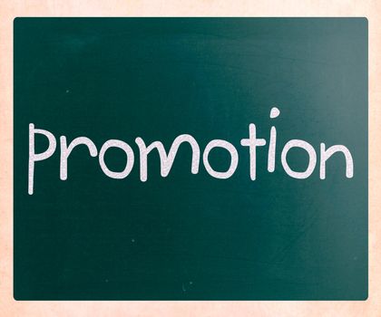The word "promotion" handwritten with white chalk on a blackboard