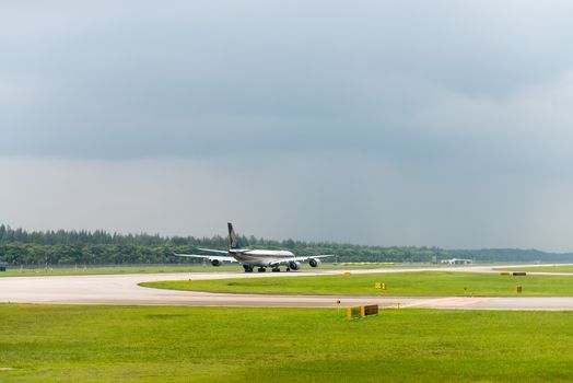 SINGAPORE - SEP 11: Singapore airlines plane speeds up on Changi airport runway on SEP 11, 2012  in Singapore. SIA is the flag carrier and 5-star airline of Singapore.